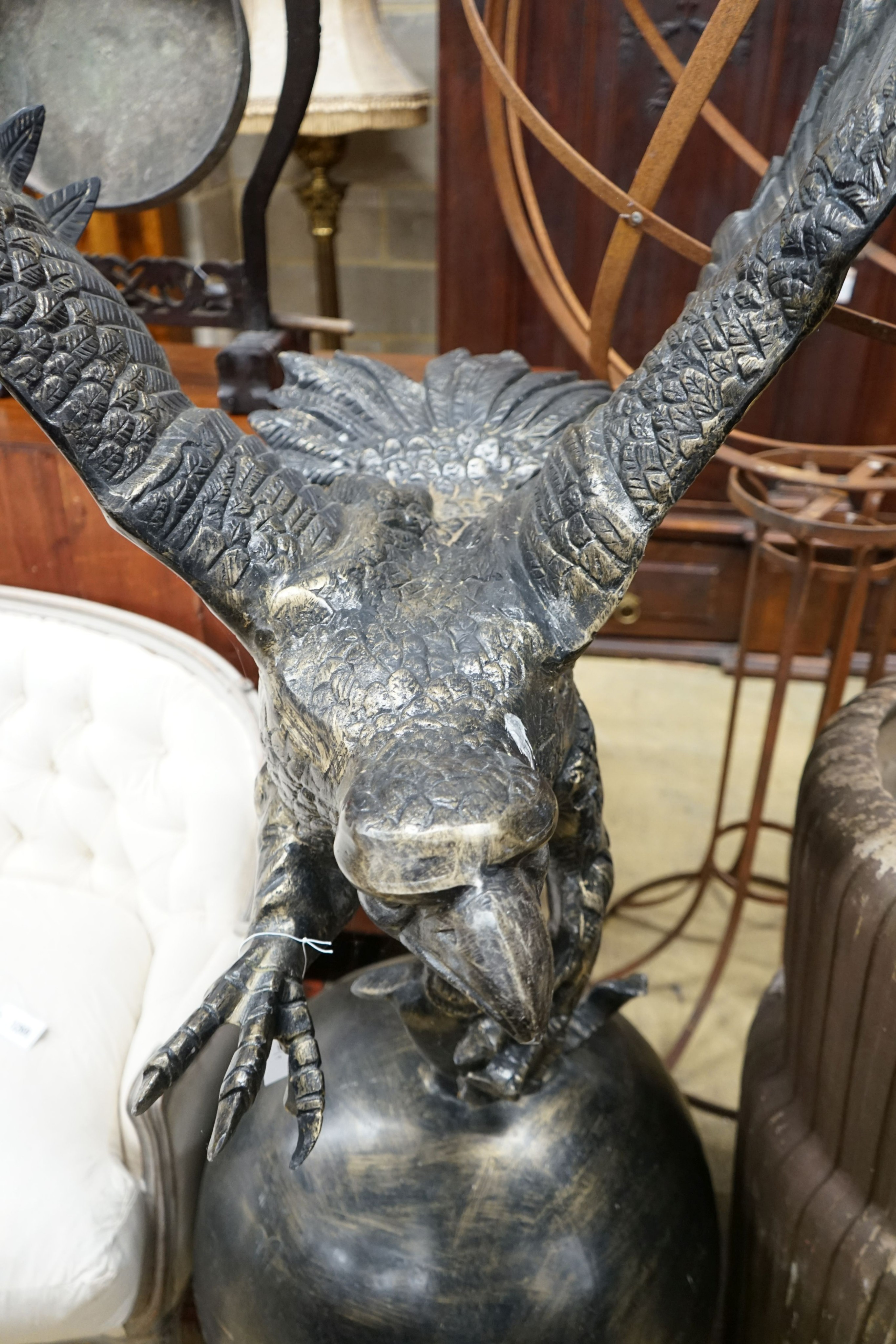A large cast metal faux bronze eagle, salmon and orb garden ornament, height 200cm